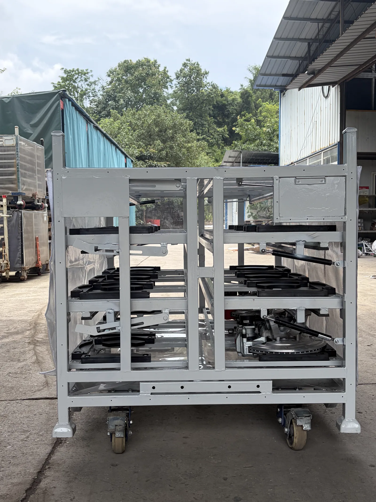 Custom automotive brake booster returnable rack with part-specific dunnage and fold-down access — configuration view 4