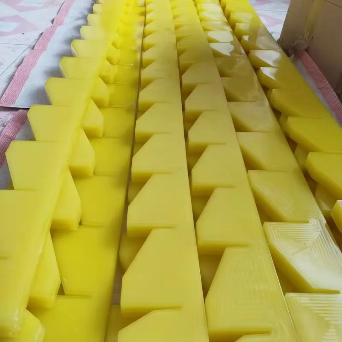 Custom yellow and black polyurethane locator blocks for automotive rack contact positions