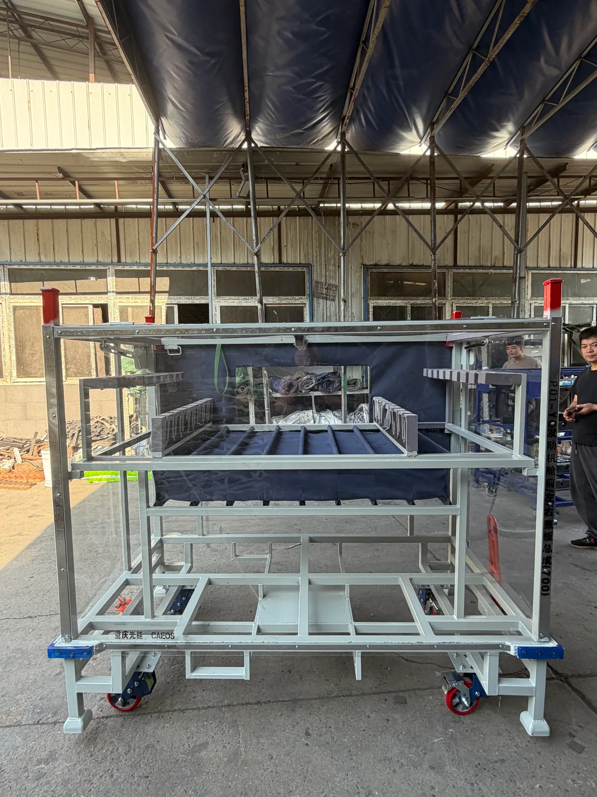 Cream steel parts trolley with clear enclosure panels, dark soft dividers, wheels and fork entry