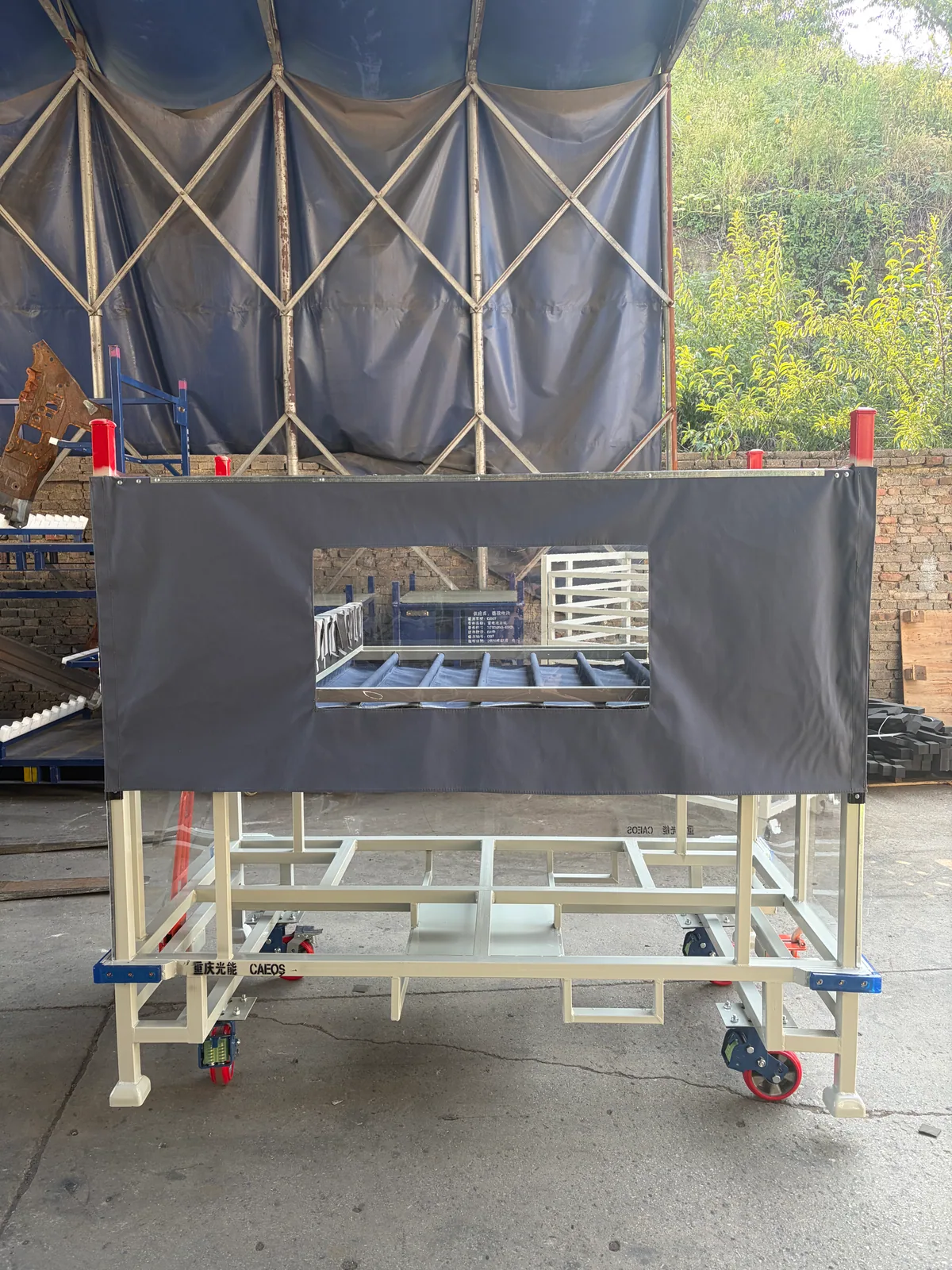 Covered face and viewing window on cream-colored automotive parts trolley