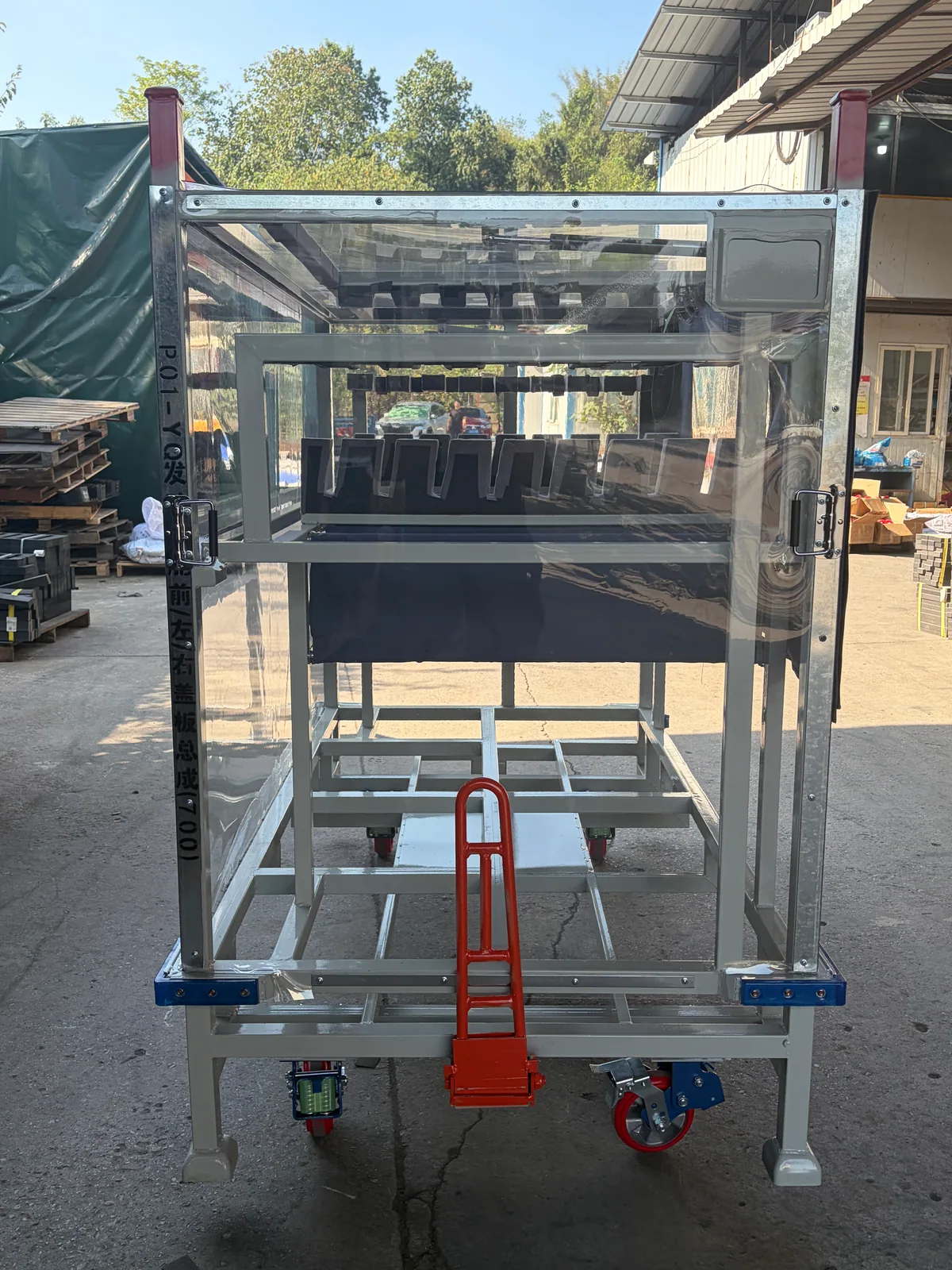 End view showing clear panels, wheeled base and fork-entry arrangement
