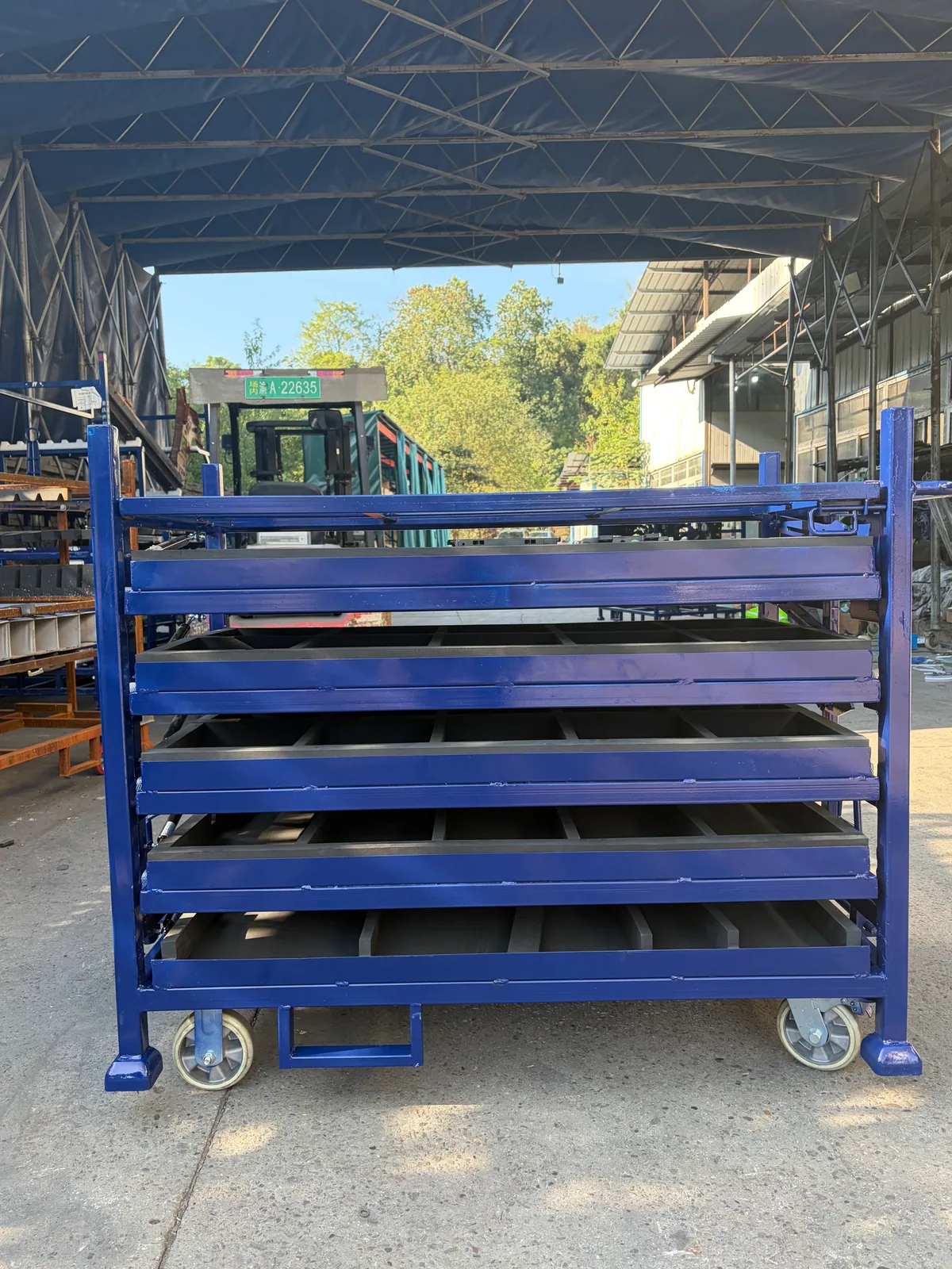 Blue multi-tier rack with trays closed and wheeled steel base